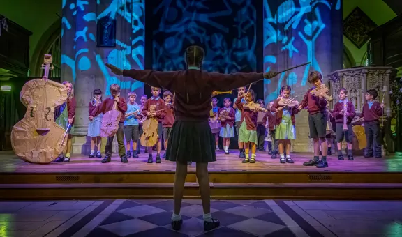 Group of young people in a theatre performing for The Arts Society Cardboard Proms 