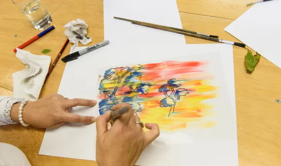 Photograph of an artist's hands creating a watercolour