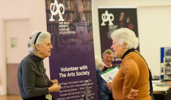 Two Arts Society volunteers talking