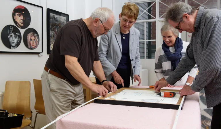 A group of Arts Society volunteers working on a project together